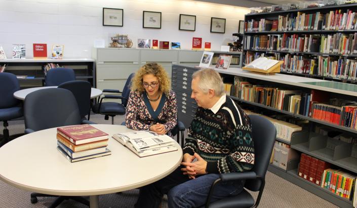 Two people sit in the Resource Centre